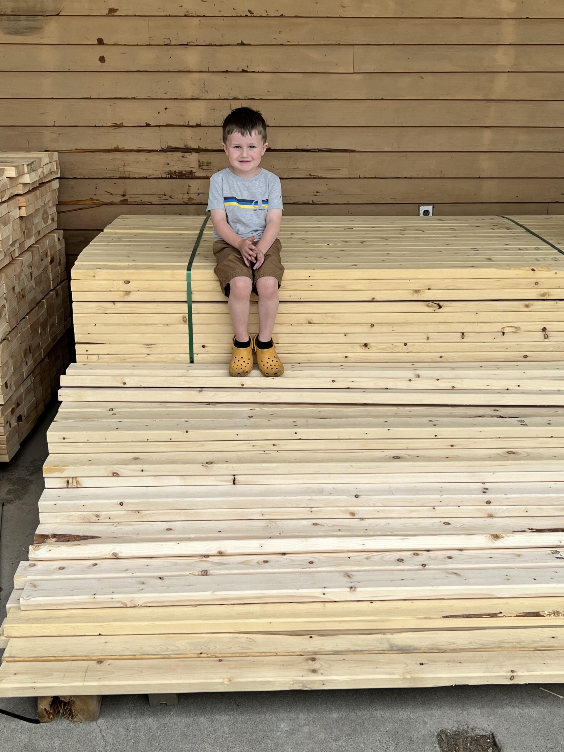 Young child sitting on wooden planks
